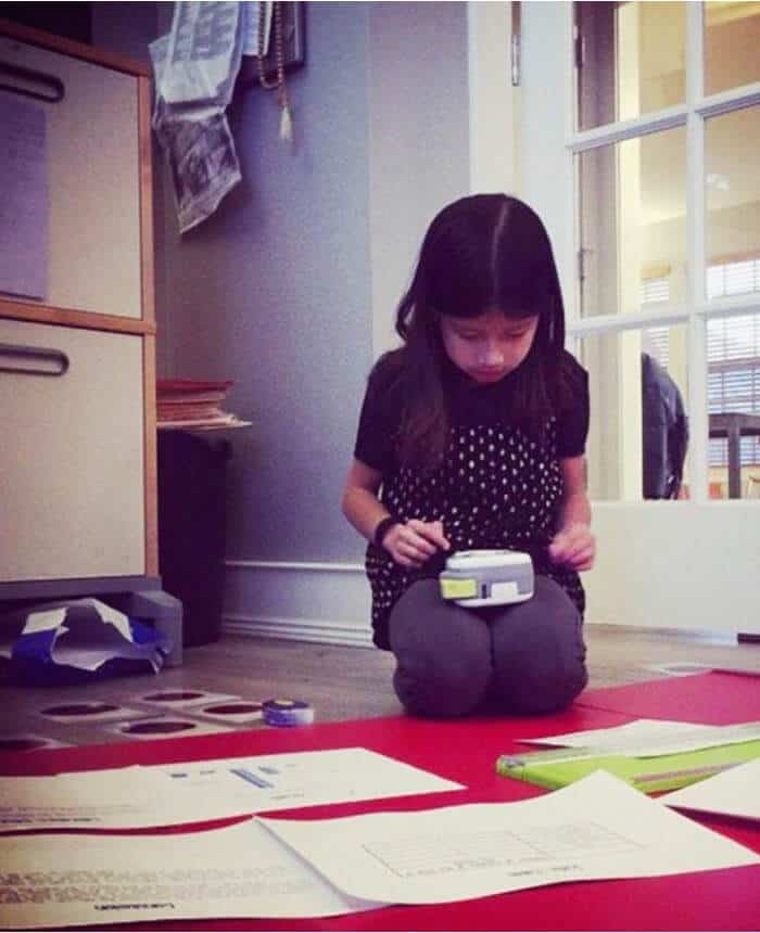 Young girl making labels