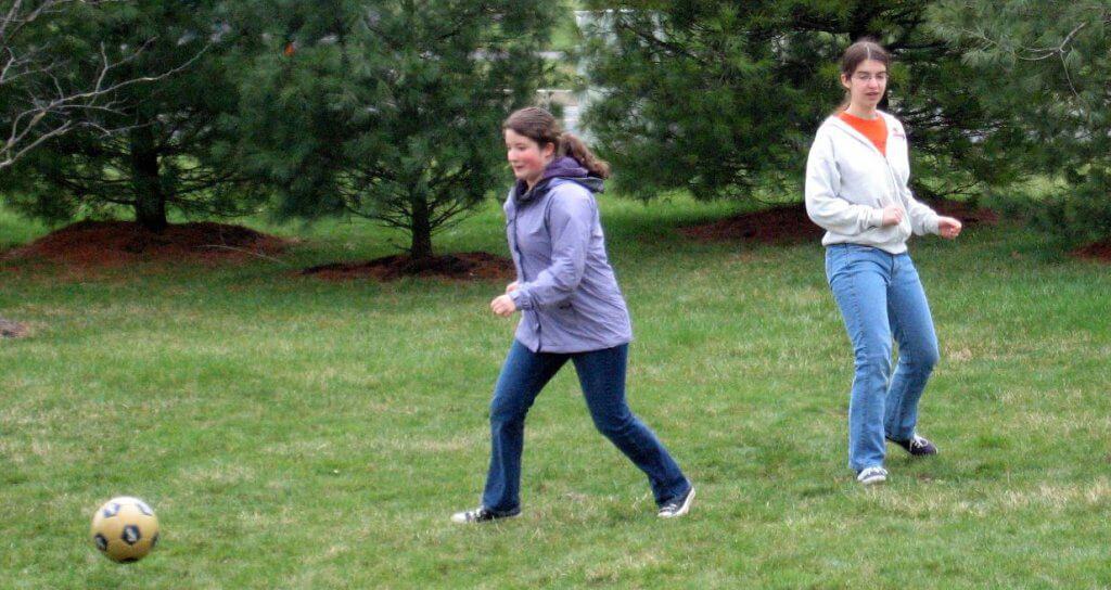 Family playing soccer