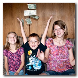 Kids throwing money into the air