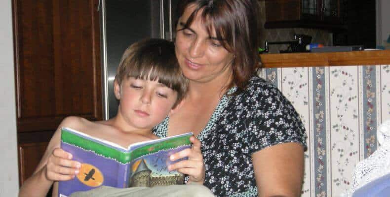A mom and a tween reading together