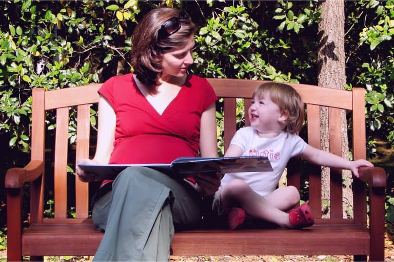 Mother reading a children's book to her daughter