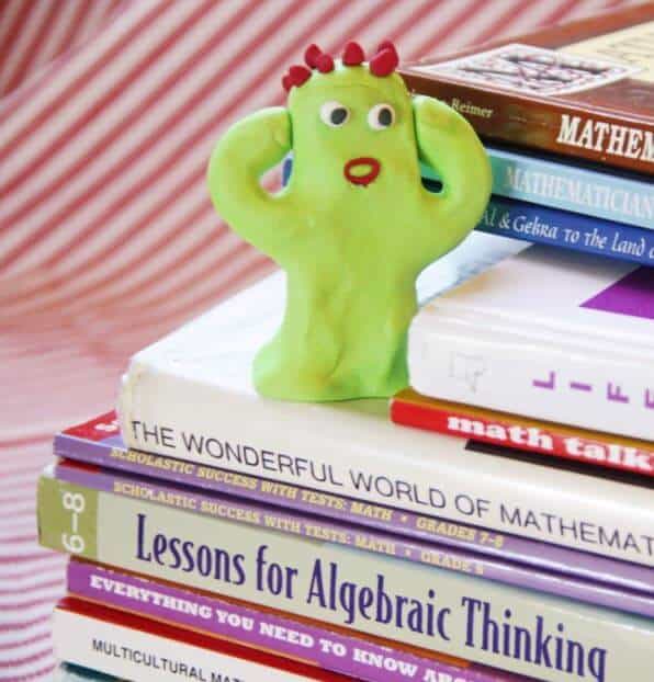 Figure holding his head because of a math overload
