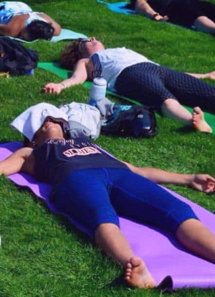Moms can do Yoga laying down in the park