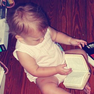 Kid reading a baby's Bible