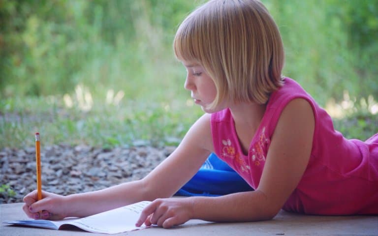 Blond girl journaling in order to become more mindful of herself