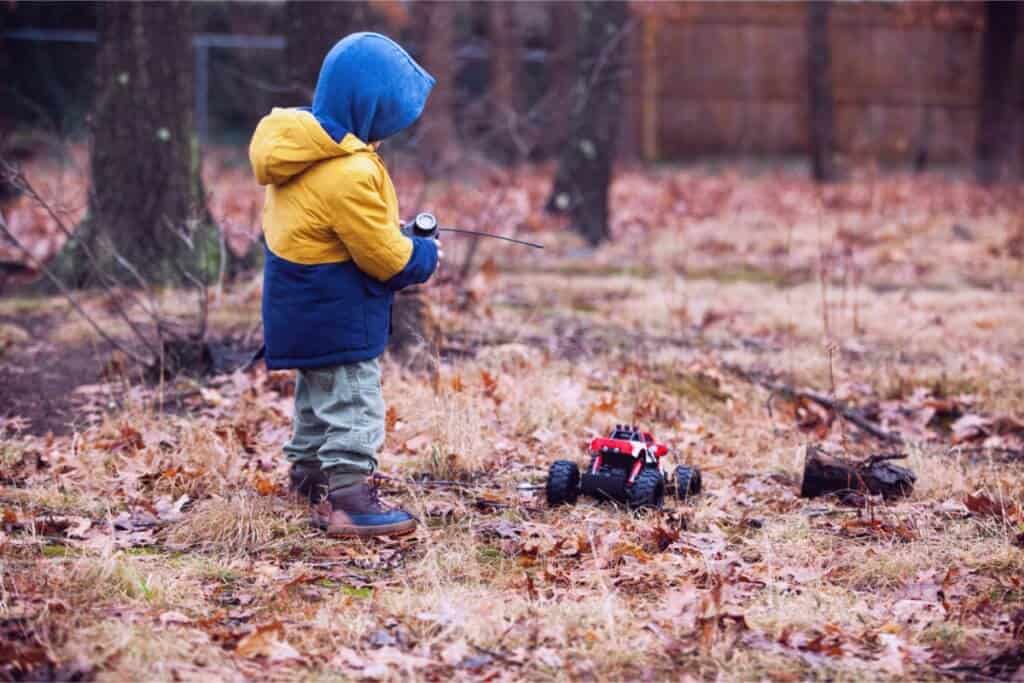 A child playing with a remote controlled car