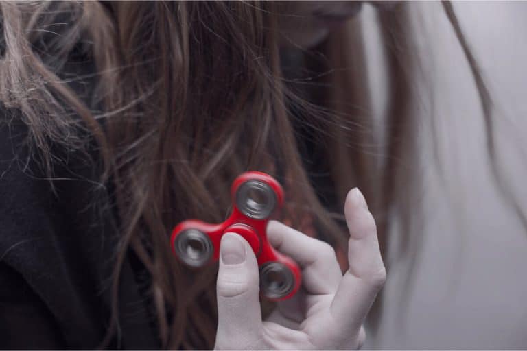 Girl with a red fidget spinner