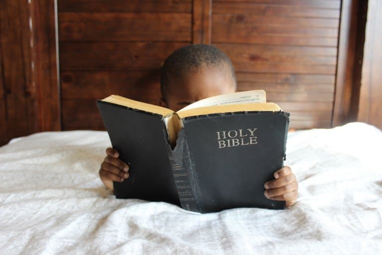 Young boy reading the Bible