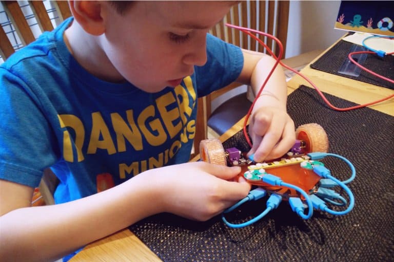 A kid building his own robot from a kit