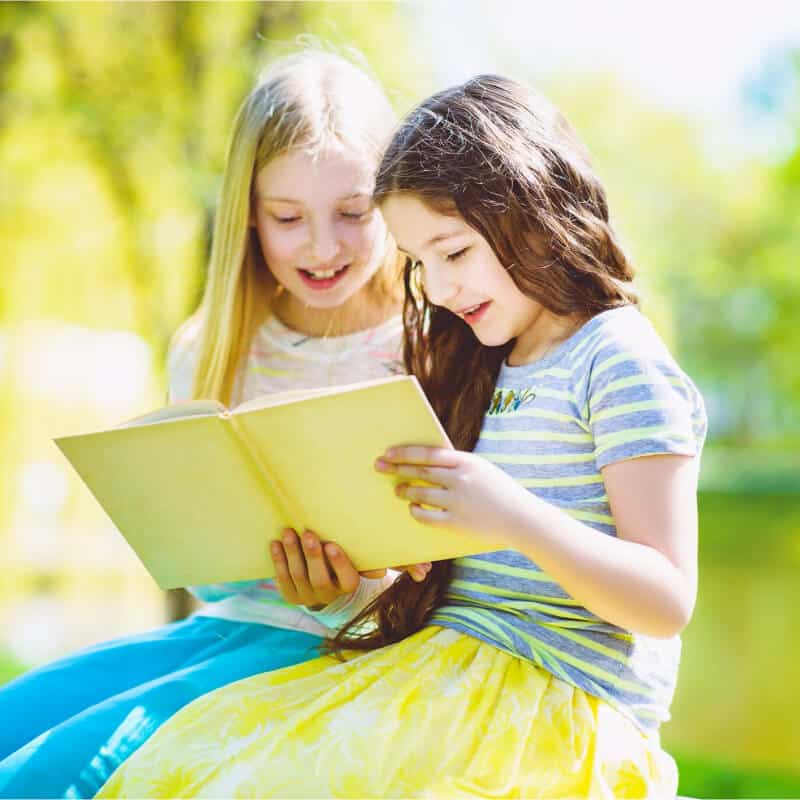 Two girls enjoying reading