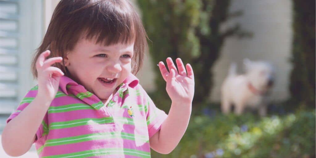 Excited child throwing up hands